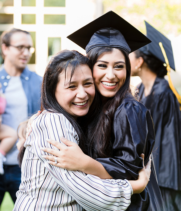 Mother and graduating daughter pose cheek to cheek for photo Doctor and nurse sitting on sofa